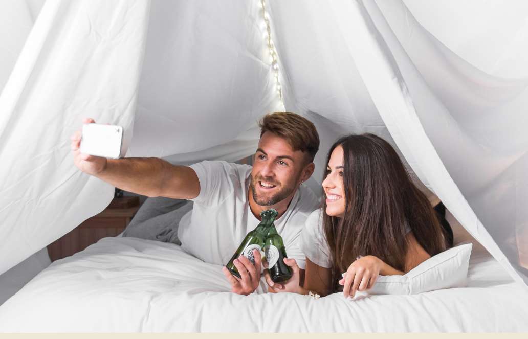 taking selfie under blanket fort