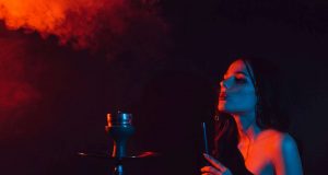young girl enjoys smoking a hookah