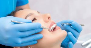 dentist examines the patients teeth at the dentist.